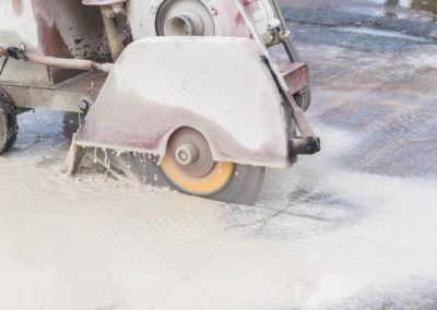 depositphotos_121864342-stock-photo-worker-cutting-concrete-road-with